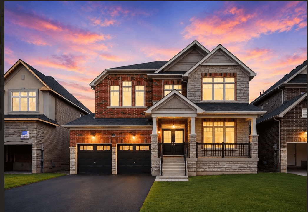 Luxury brick home with a double garage at sunset